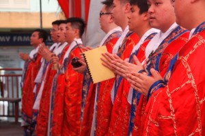 Men draped in red vestments are represented as the ‘Sangha’ (photo Sugen Ramiah)