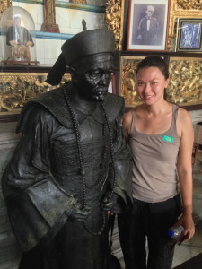 Brownie Simone posing next to statue of Chung Keng Quee